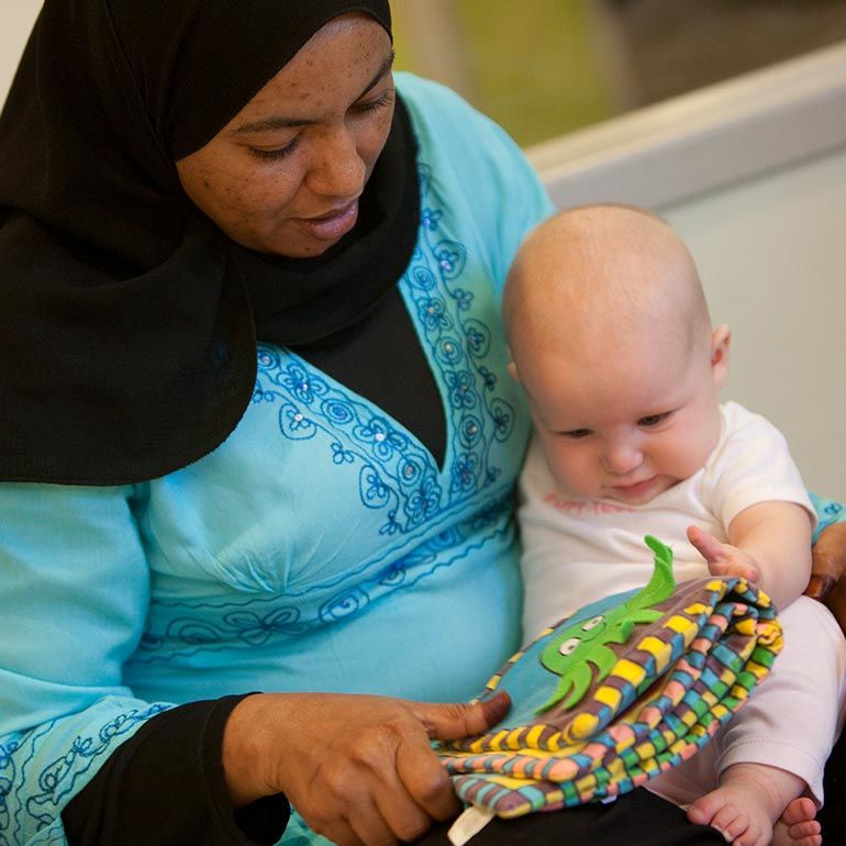 Bright Horizons teacher teaching an infant