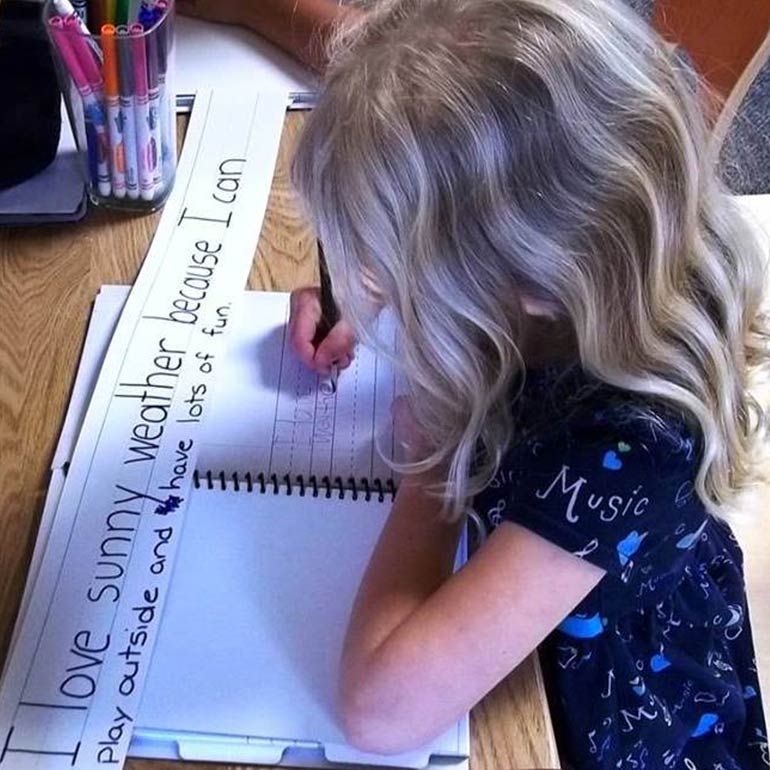 Bright Horizons kindergarten Prep Student practicing her letters