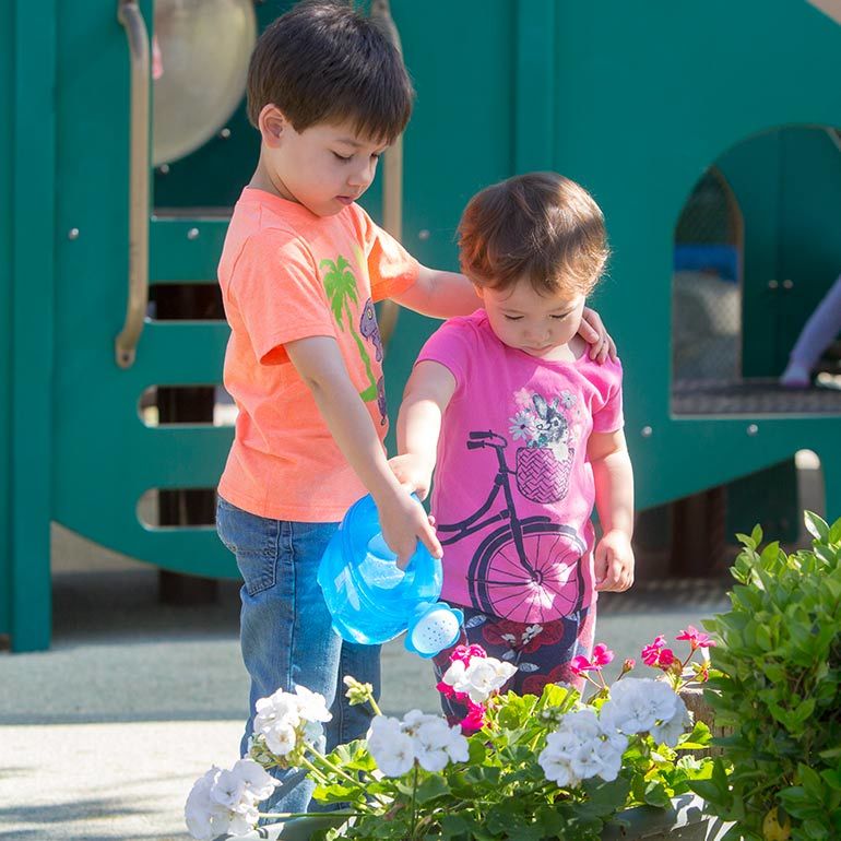 Bright Horizons Preschool Students watering the flowers