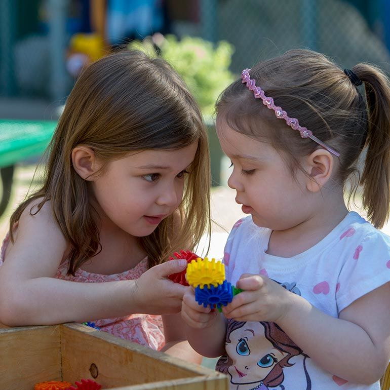 Bright Horizons Toddler Students playing with gears together