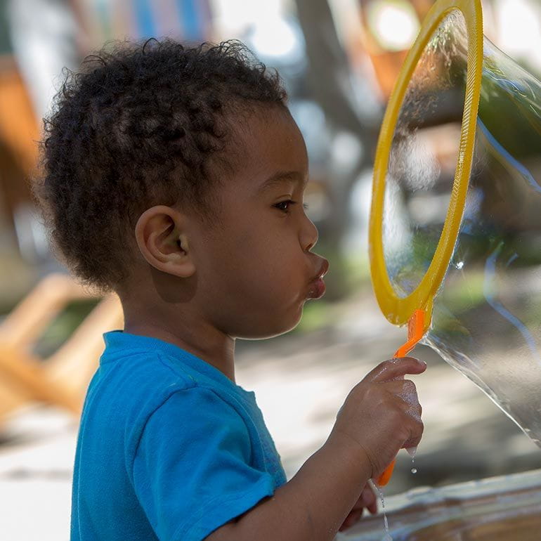Bright Horizons Toddler student blowing a bubble