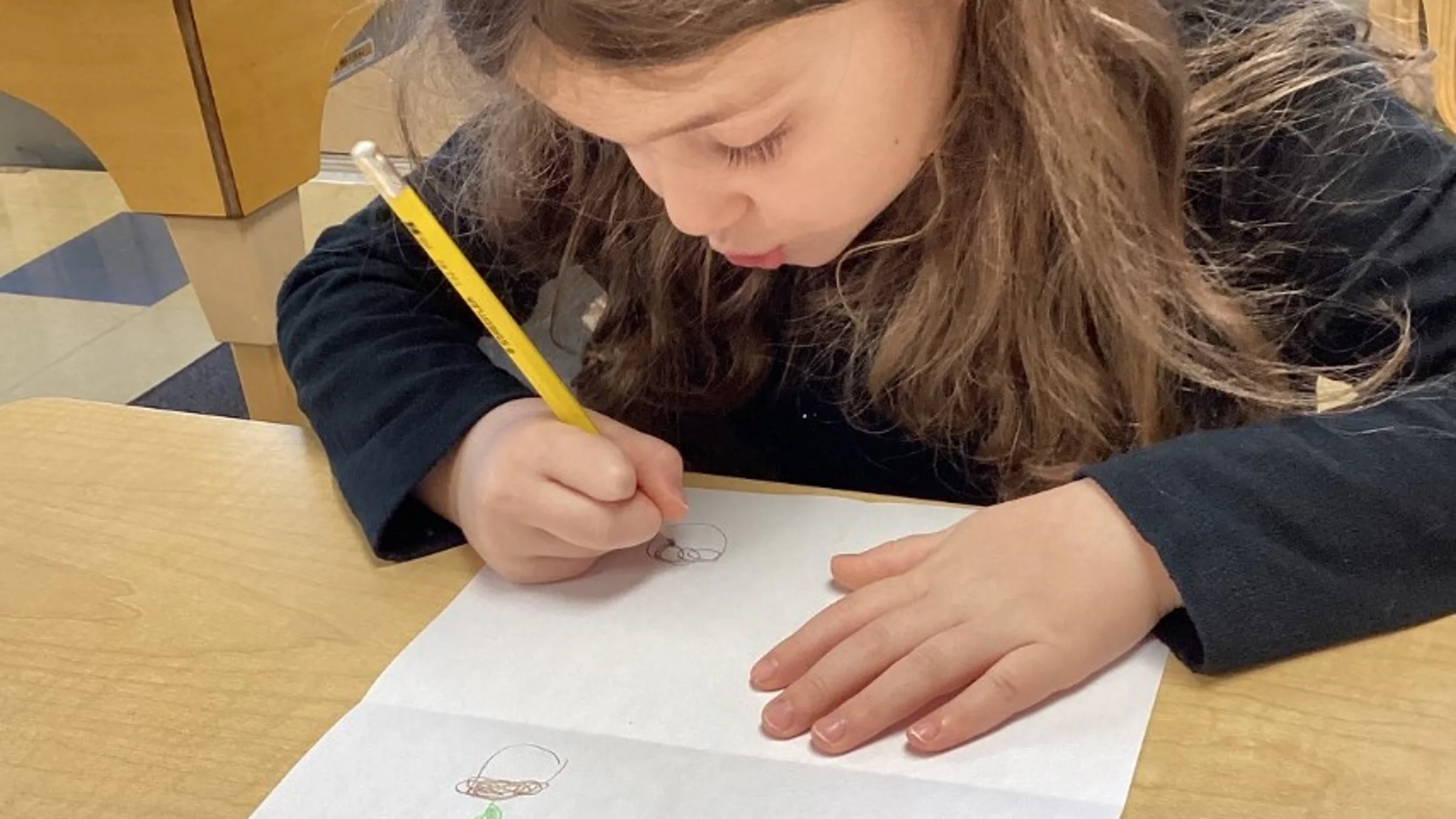 Girl writing on a piece of paper