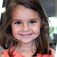 Kindergarten Prep girl with brown hair standing and smiling