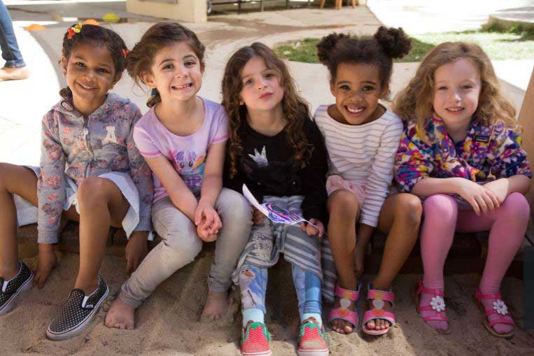 Bright Horizons students sitting at the sandbox