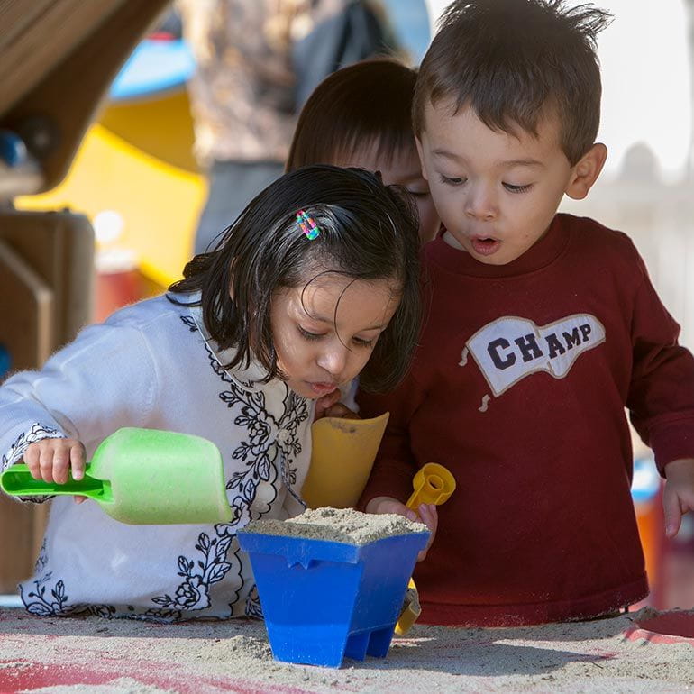 Bright Horizons Preschool Students play with sand